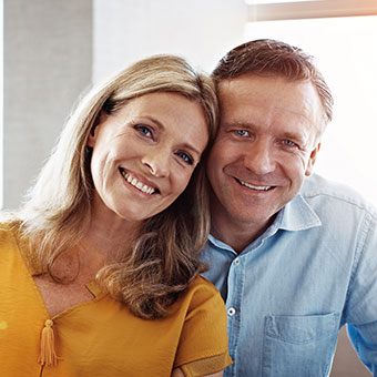 Couple smiling and looking at camera. Link to Life Stage Gift Planner Under Age 45 Situations.