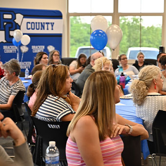 Crowd of people at tables during event. Read about Gifts That Protect Your Assets Crowd of people at tables during event. Read about Gifts That Protect Your Assets